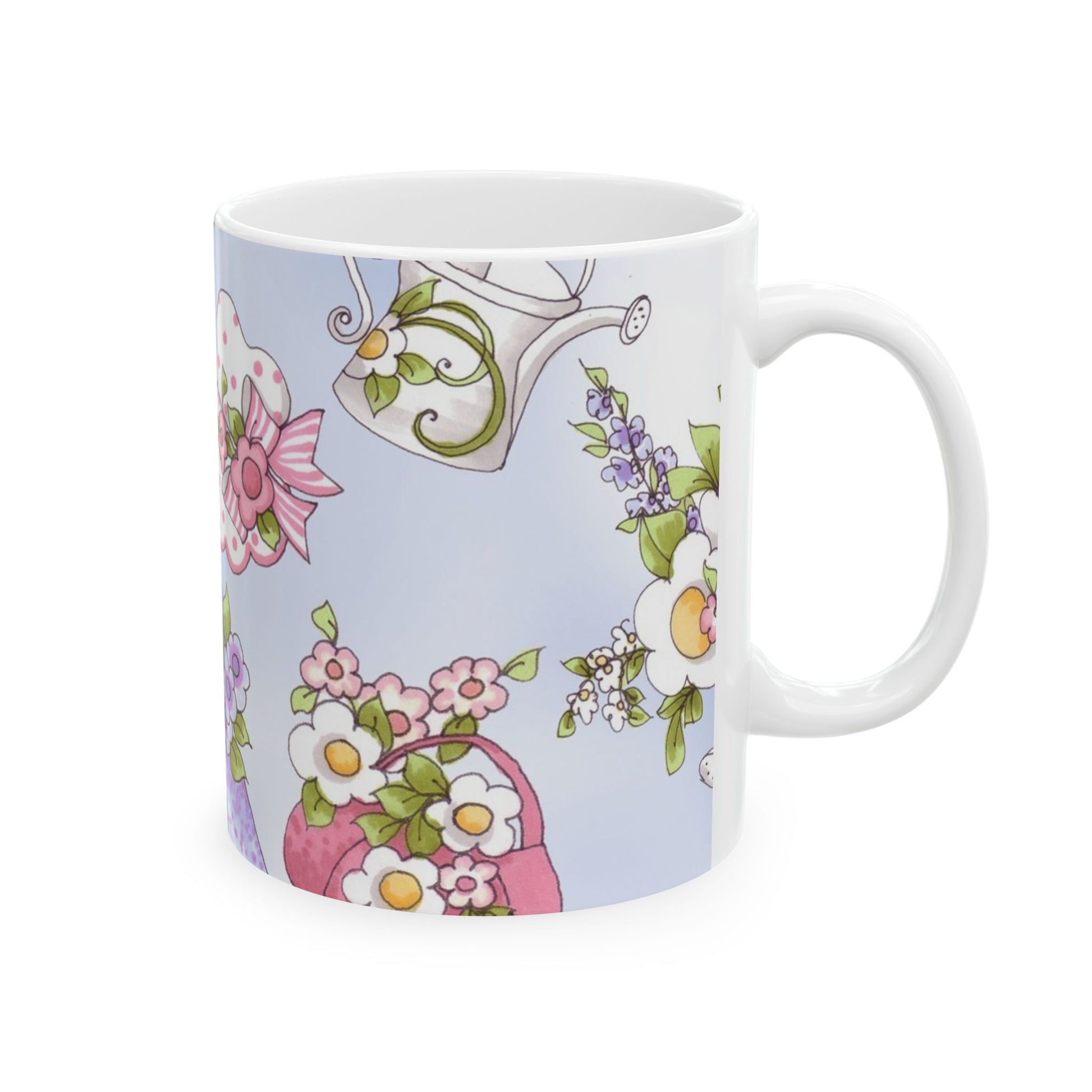 White mug with colorful floral patterns and a watering can on a light blue background.
