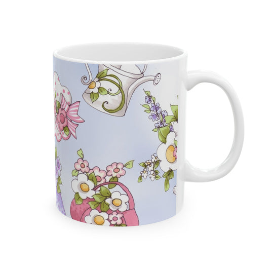 White mug with colorful floral patterns and a watering can on a light blue background.
