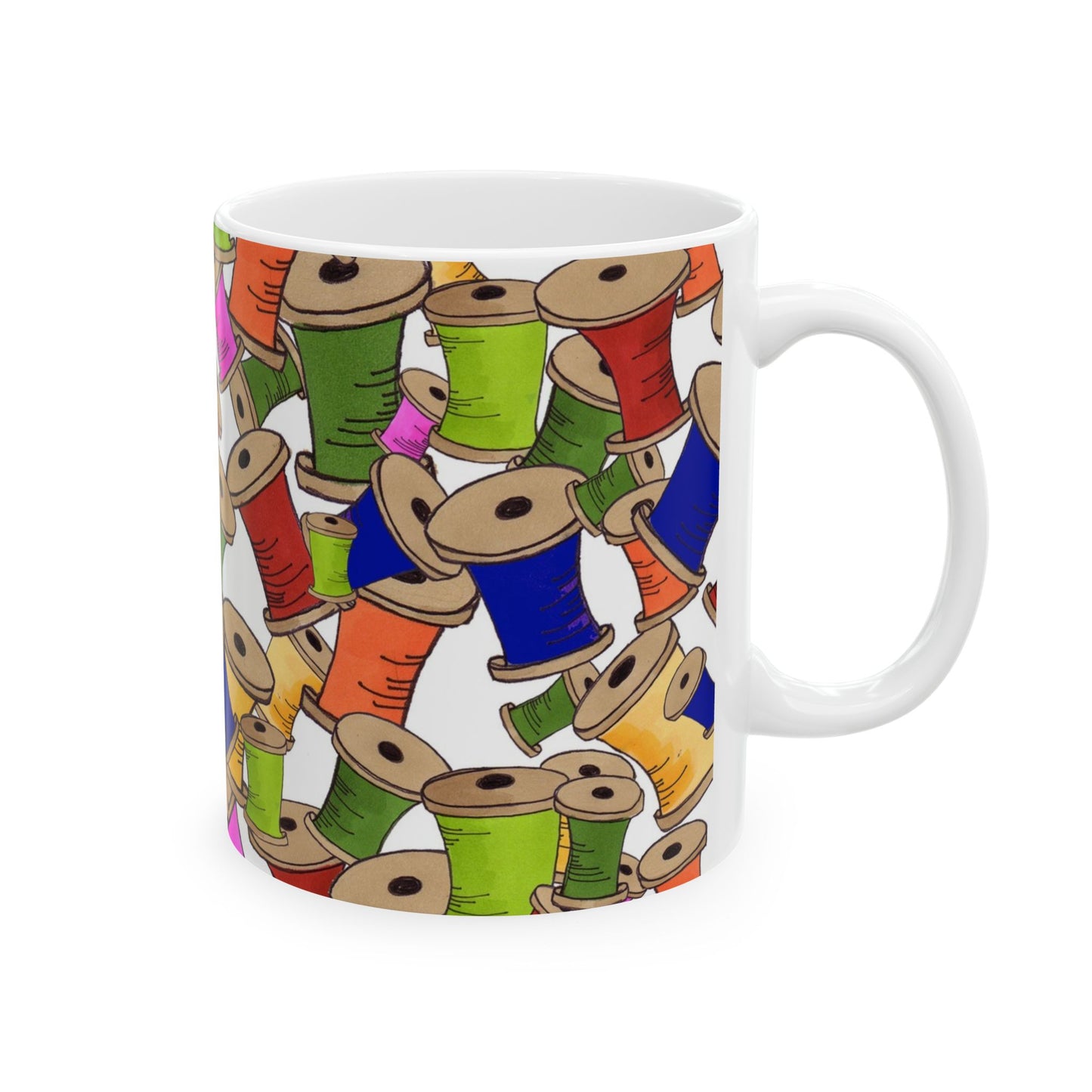 White mug with colorful spool pattern in blue, green, red, orange, and pink on a white background.