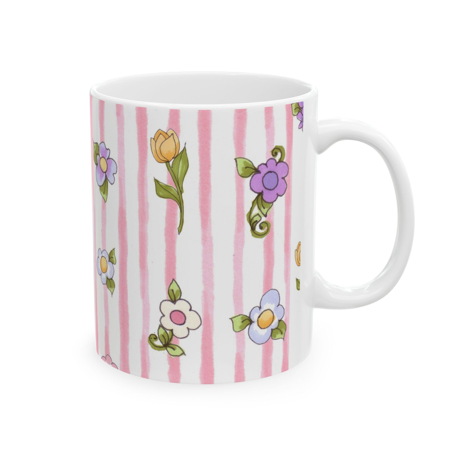 White mug with pink stripes and colorful floral patterns featuring purple, yellow, and white flowers.