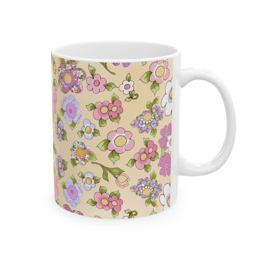 White mug with colorful floral patterns in pink, purple, and yellow on a beige background.