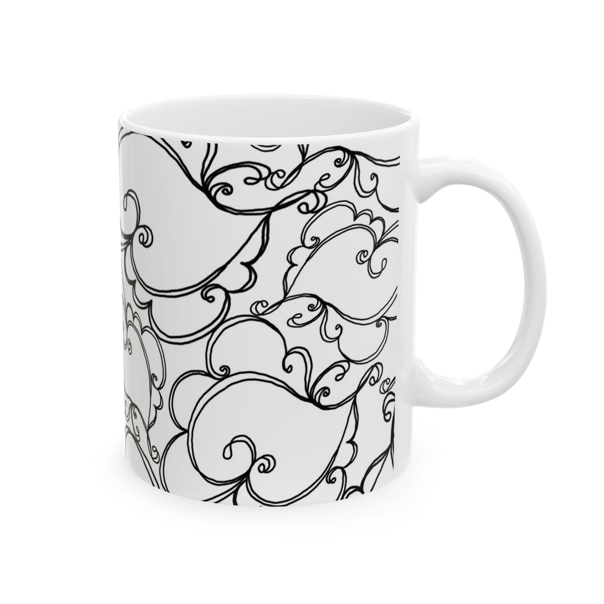 White mug with intricate black swirl and leaf patterns covering the surface.