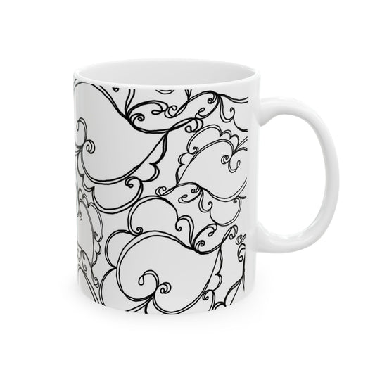White mug with intricate black swirl and leaf patterns covering the surface.