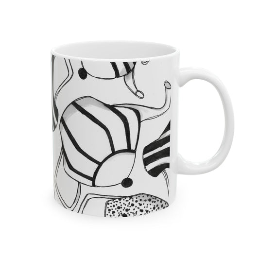 White mug with abstract black line art of stripes, dots, and curves.
