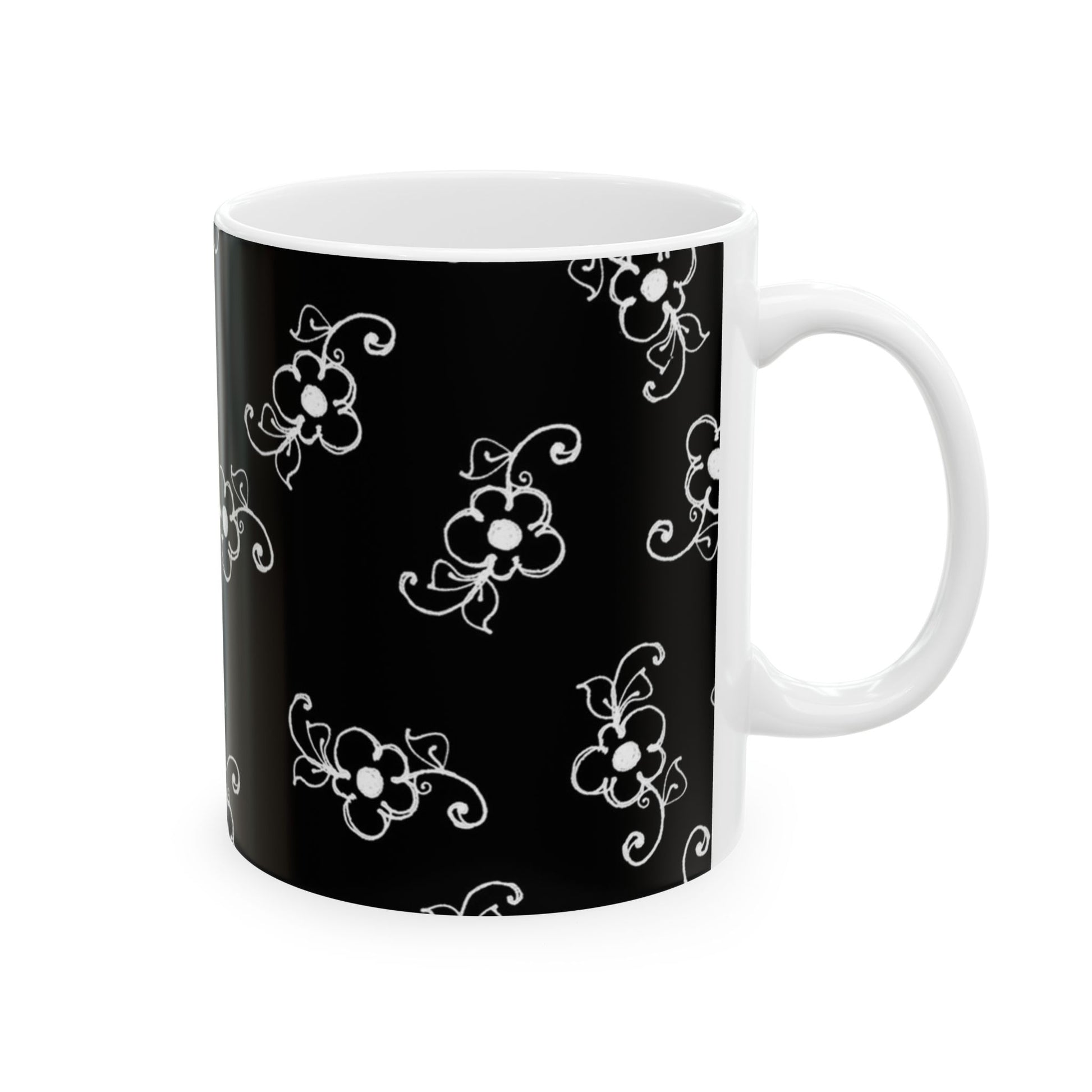 Black mug with white floral pattern and a white handle.