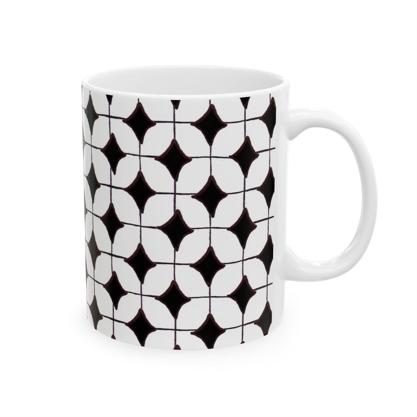 White mug with black geometric pattern of interlocking diamonds and circles.