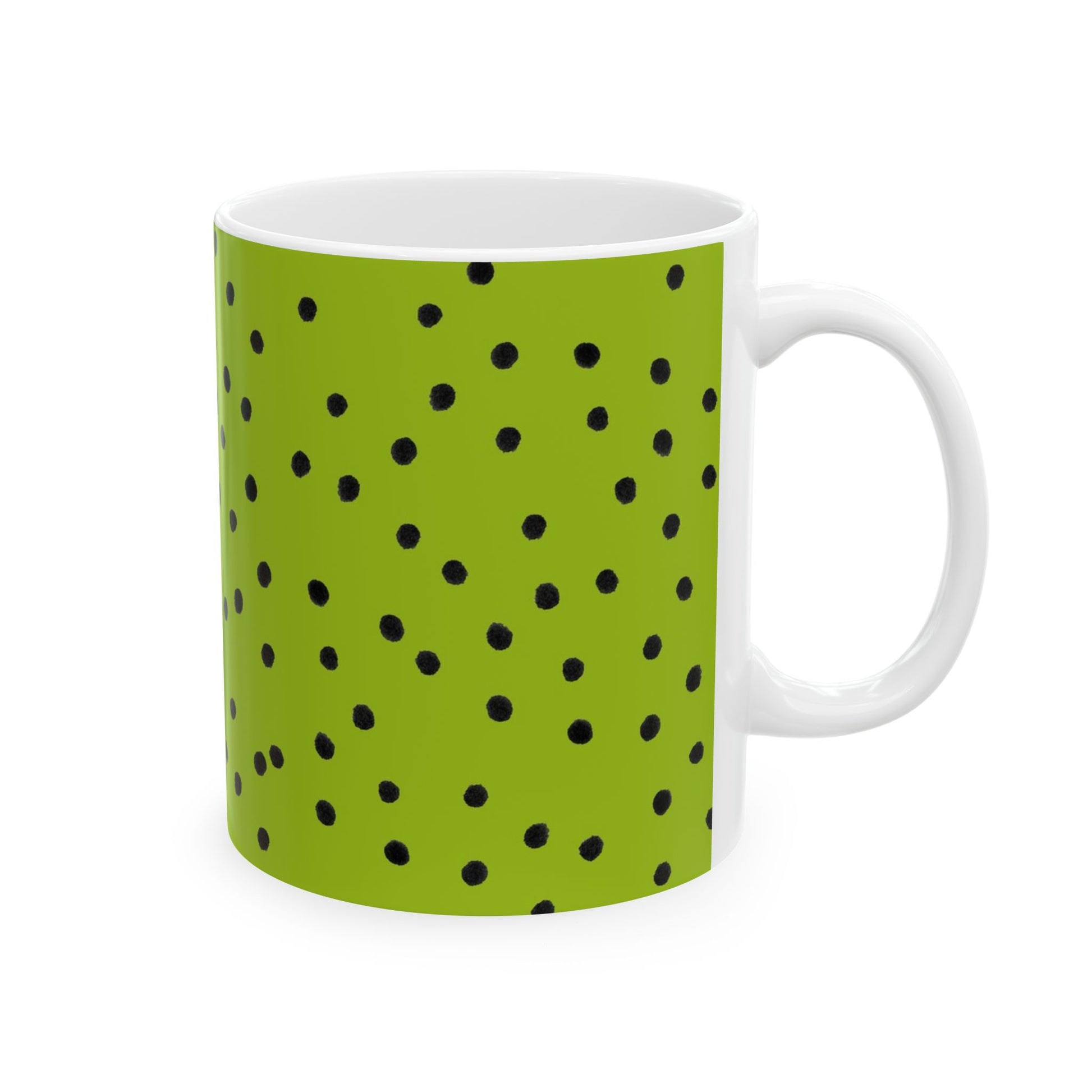 Green mug with black polka dots and a white handle.
