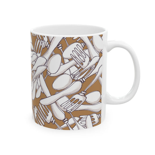 White mug with brown background featuring a pattern of overlapping white forks and spoons.