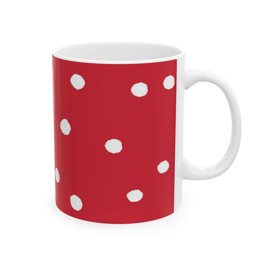 Red mug with white polka dots and a white interior.