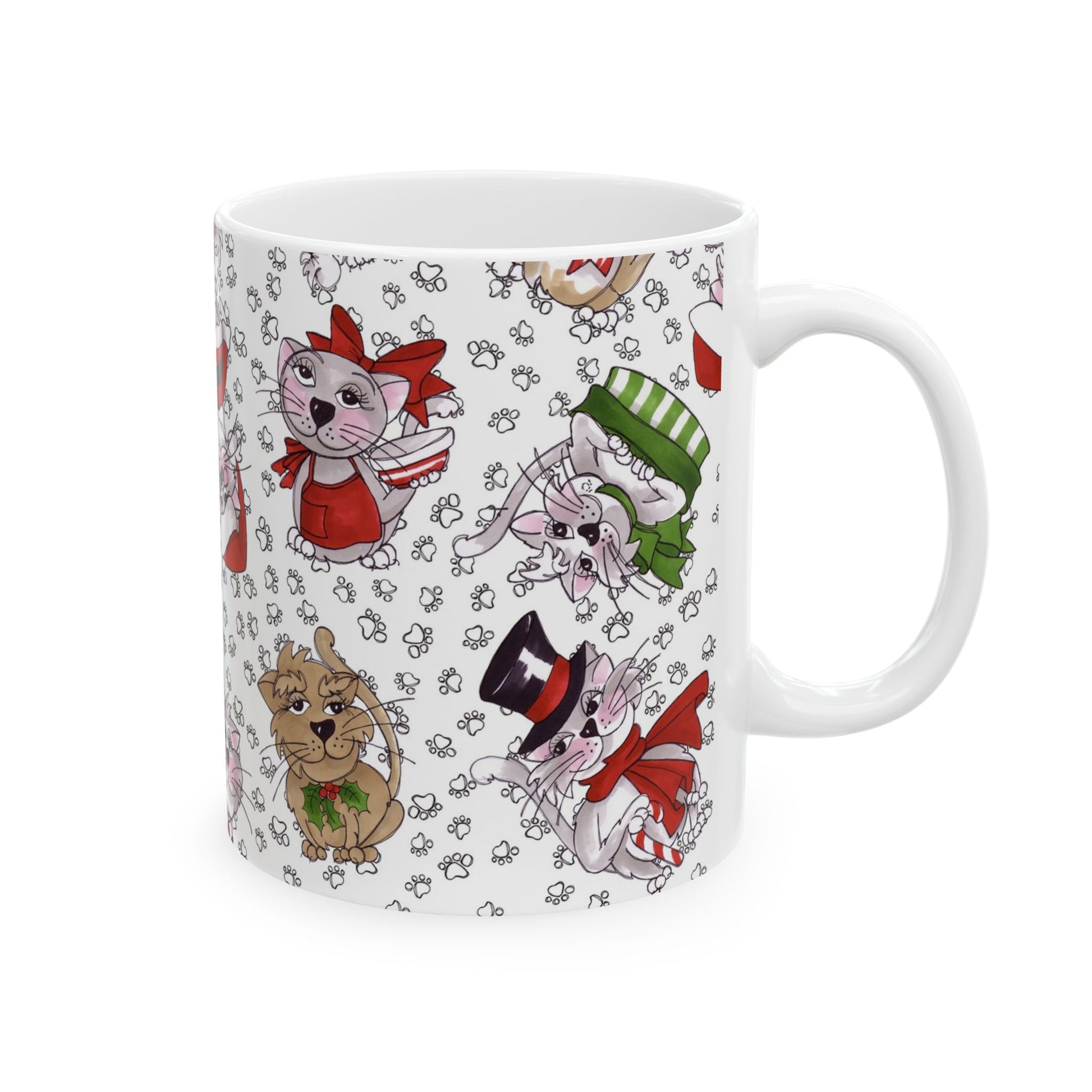 White mug with cartoon cats in red, green, and black outfits, surrounded by paw prints.