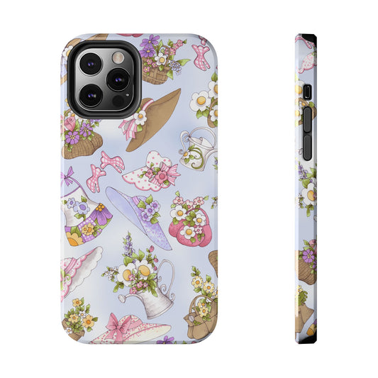 Pastel phone case with floral hats and baskets on a light blue background.