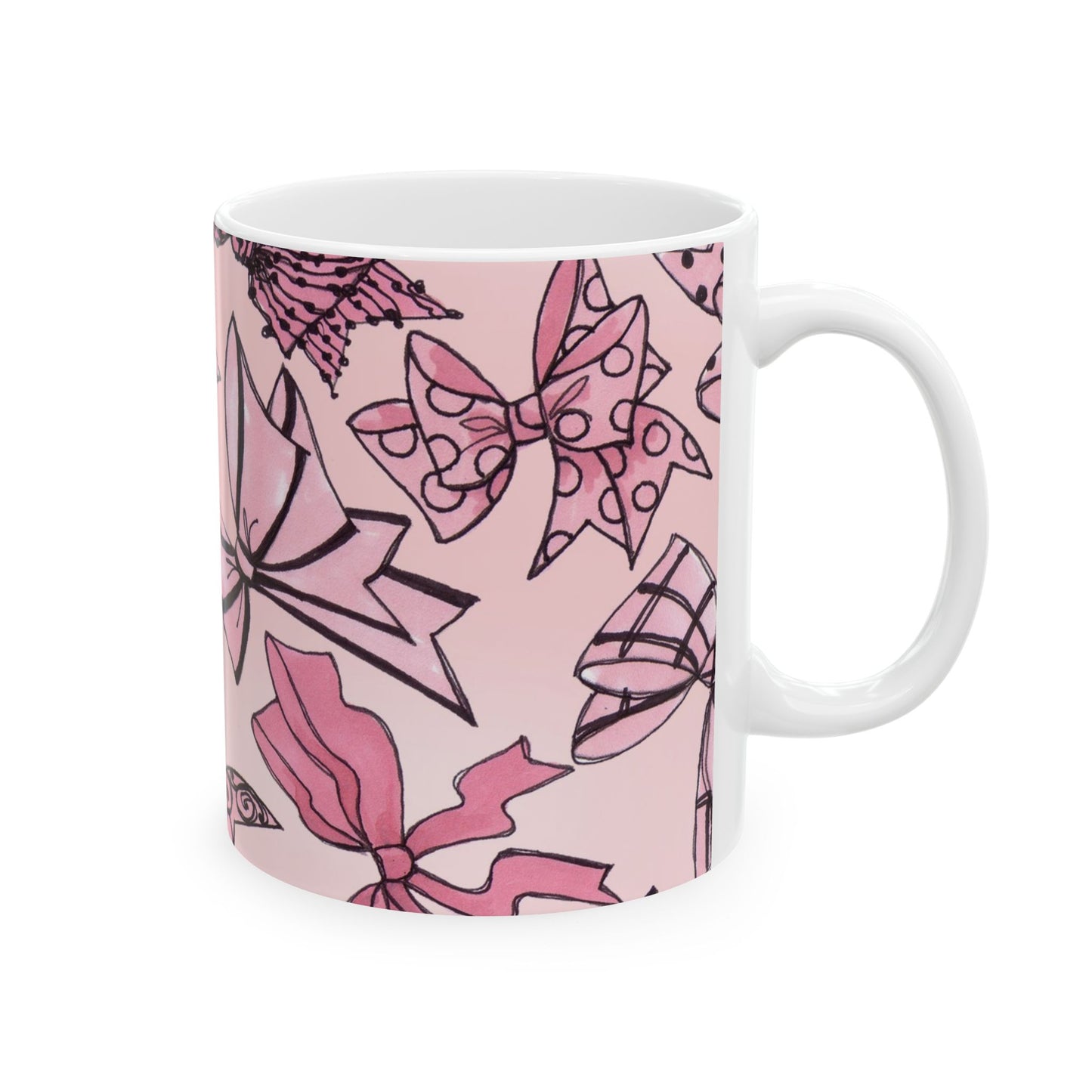 White mug with pink bow patterns and black outlines on a light pink background.