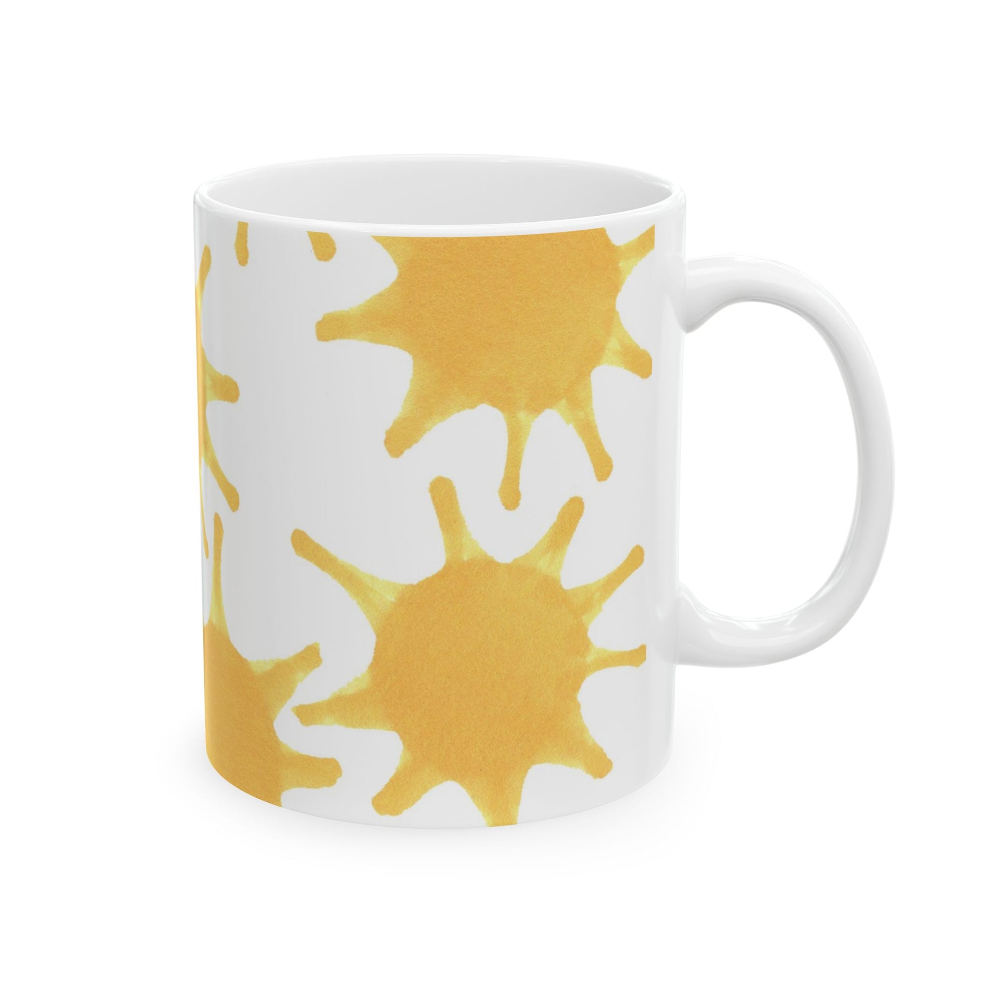 White mug with yellow sunburst patterns on the side.