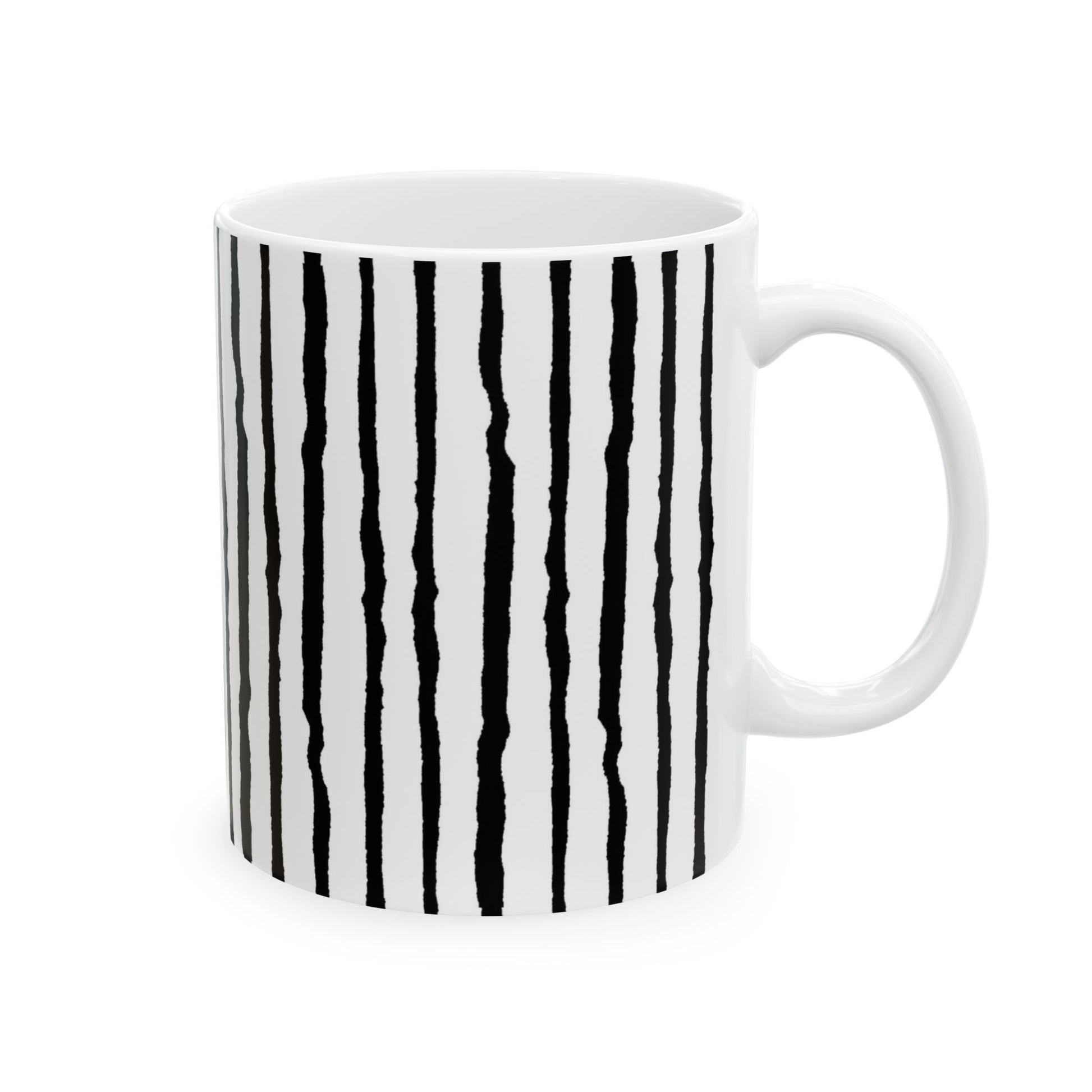 White mug with irregular black vertical stripes and a white handle.