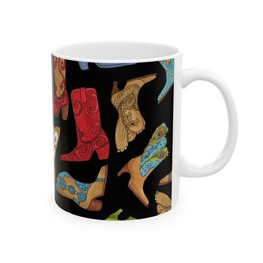 White mug with colorful cowboy boots design on a black background.