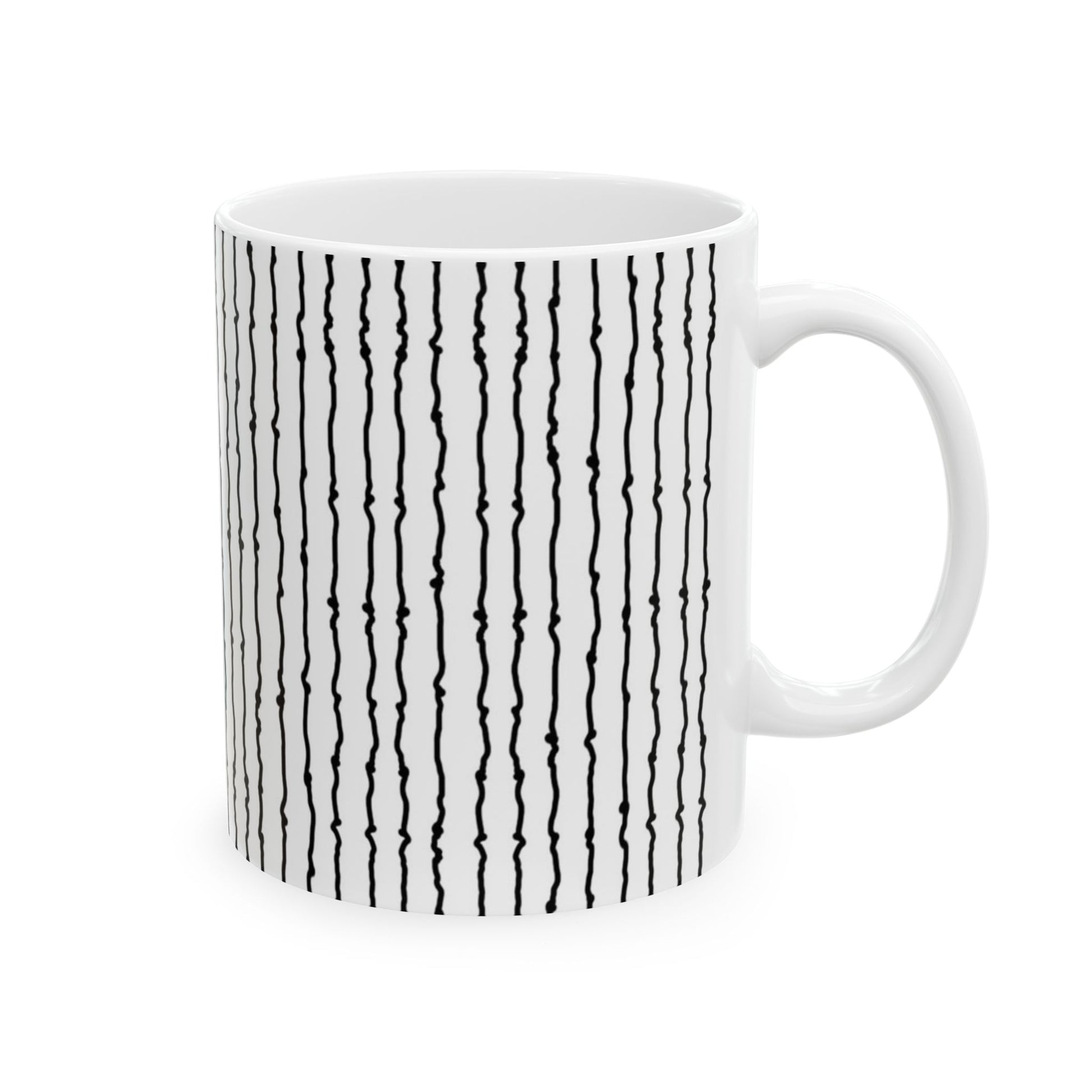 White mug with vertical black squiggly lines, emphasizing a simple, modern design.