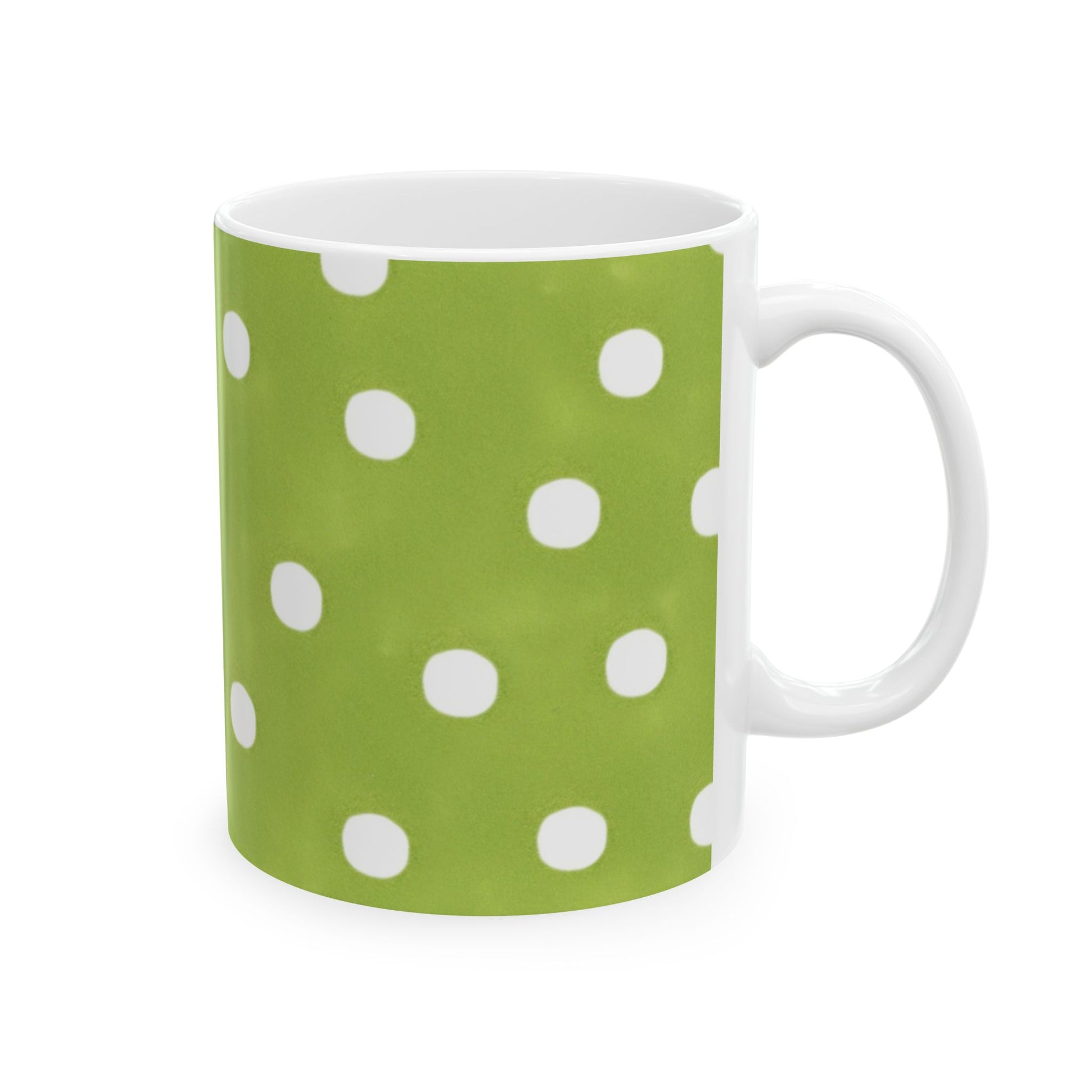 Green mug with white polka dots, handle on the right side.
