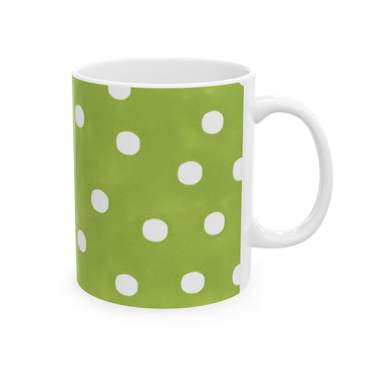 Green mug with white polka dots, handle on the right side.
