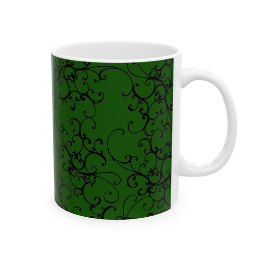 Green mug with black swirling vine pattern, white interior, on a plain white background.