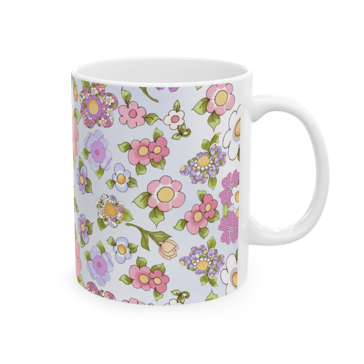 White mug with a colorful floral pattern of pink, purple, and green flowers on a light background.