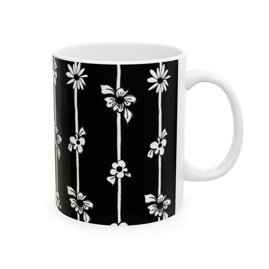 Black mug with white vertical floral pattern featuring daisies and other flowers.