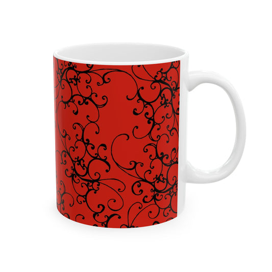 White mug with intricate black swirl patterns on a vibrant red background.