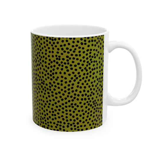 White mug with olive green and black polka dot pattern covering the surface.