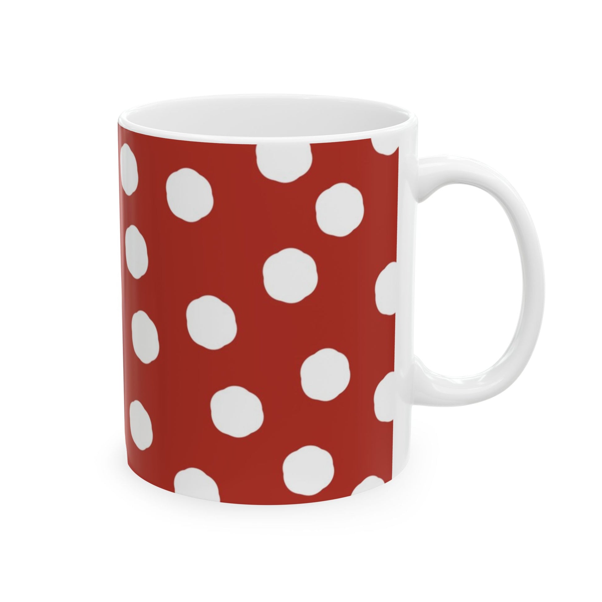 Red mug with white polka dots and a white handle.