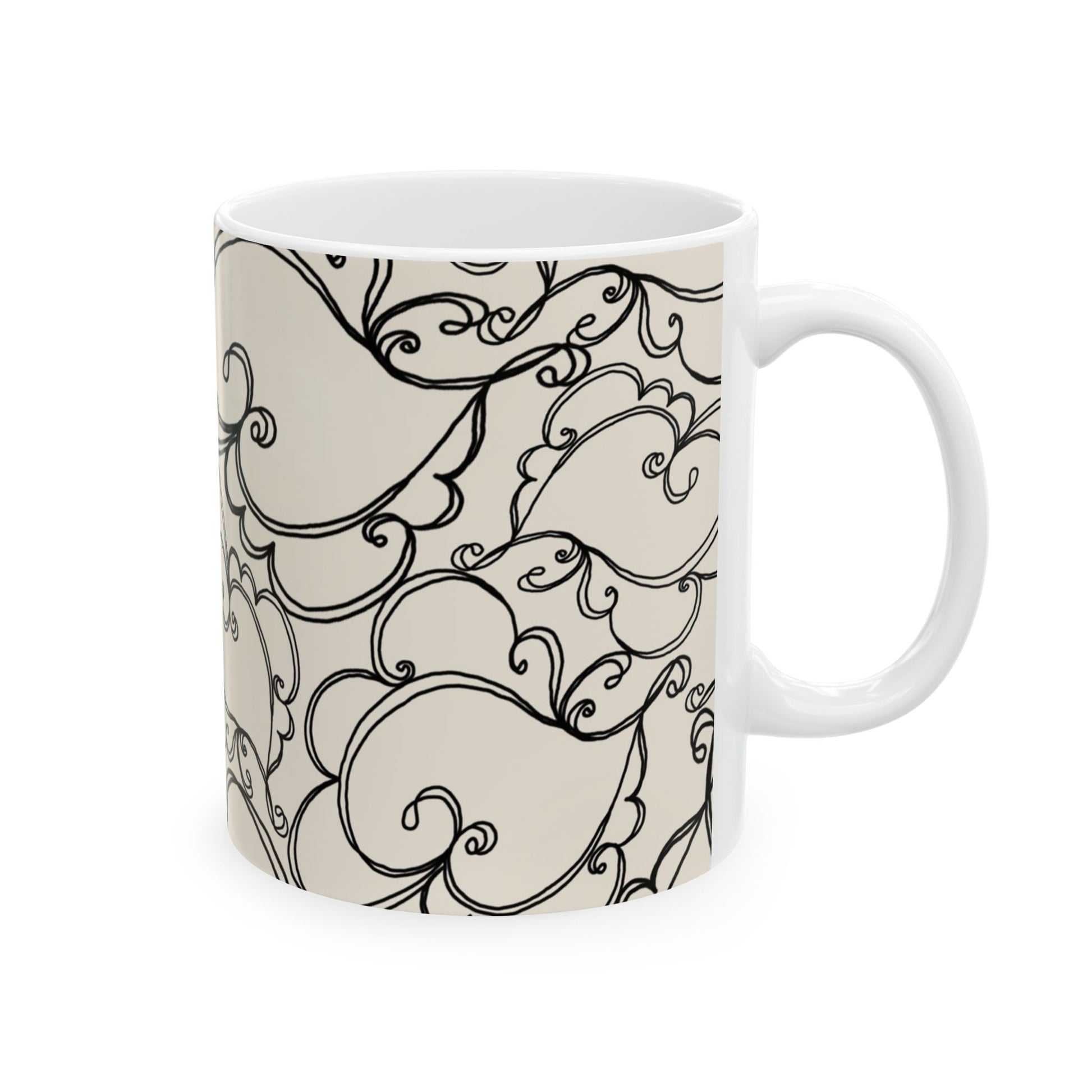White mug with intricate black swirl patterns on a beige background.