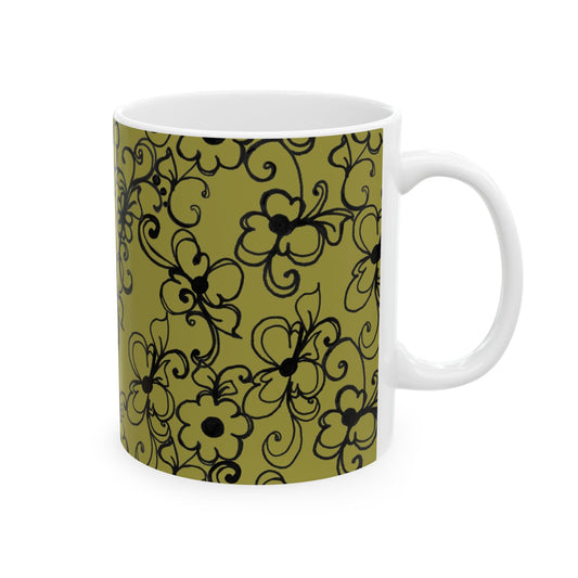 White mug with olive green floral pattern and black swirling lines.