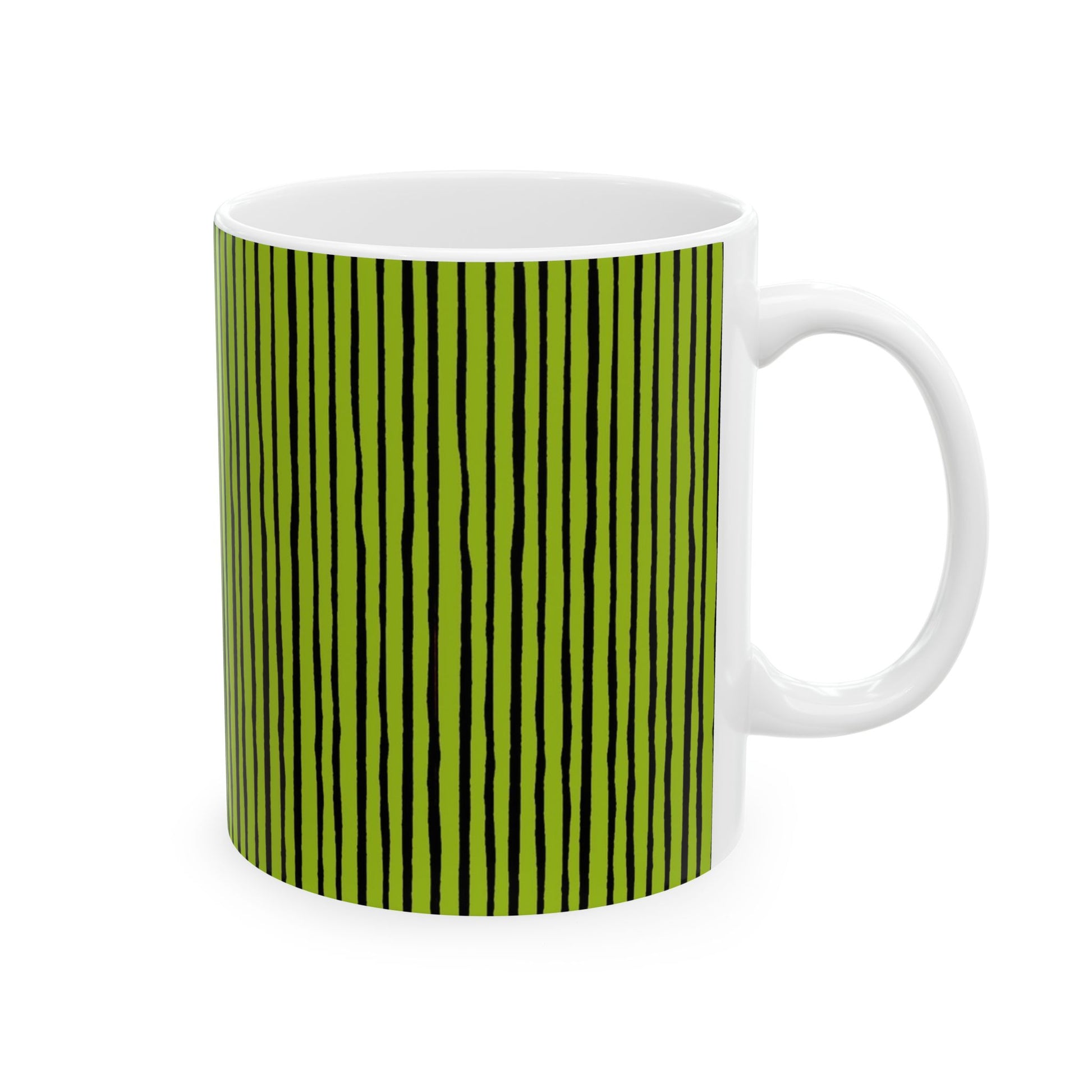 White mug with vertical black stripes on a green background.