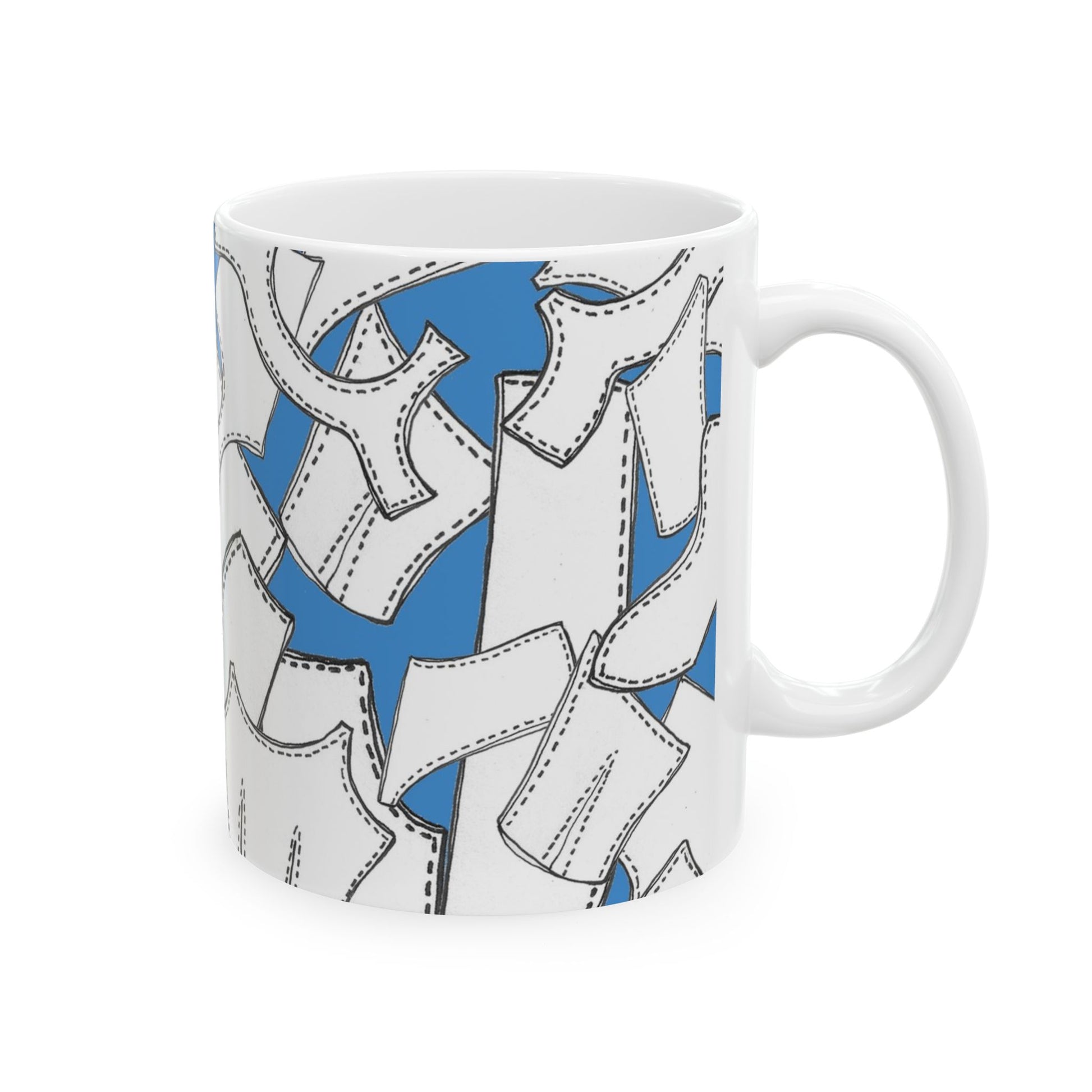 White mug with abstract black-outlined shapes on blue background.