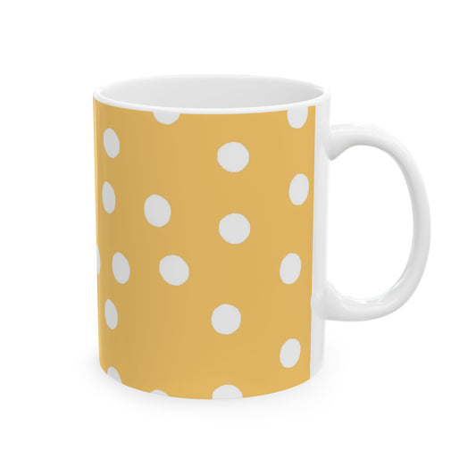 Yellow mug with white polka dots and a white handle.