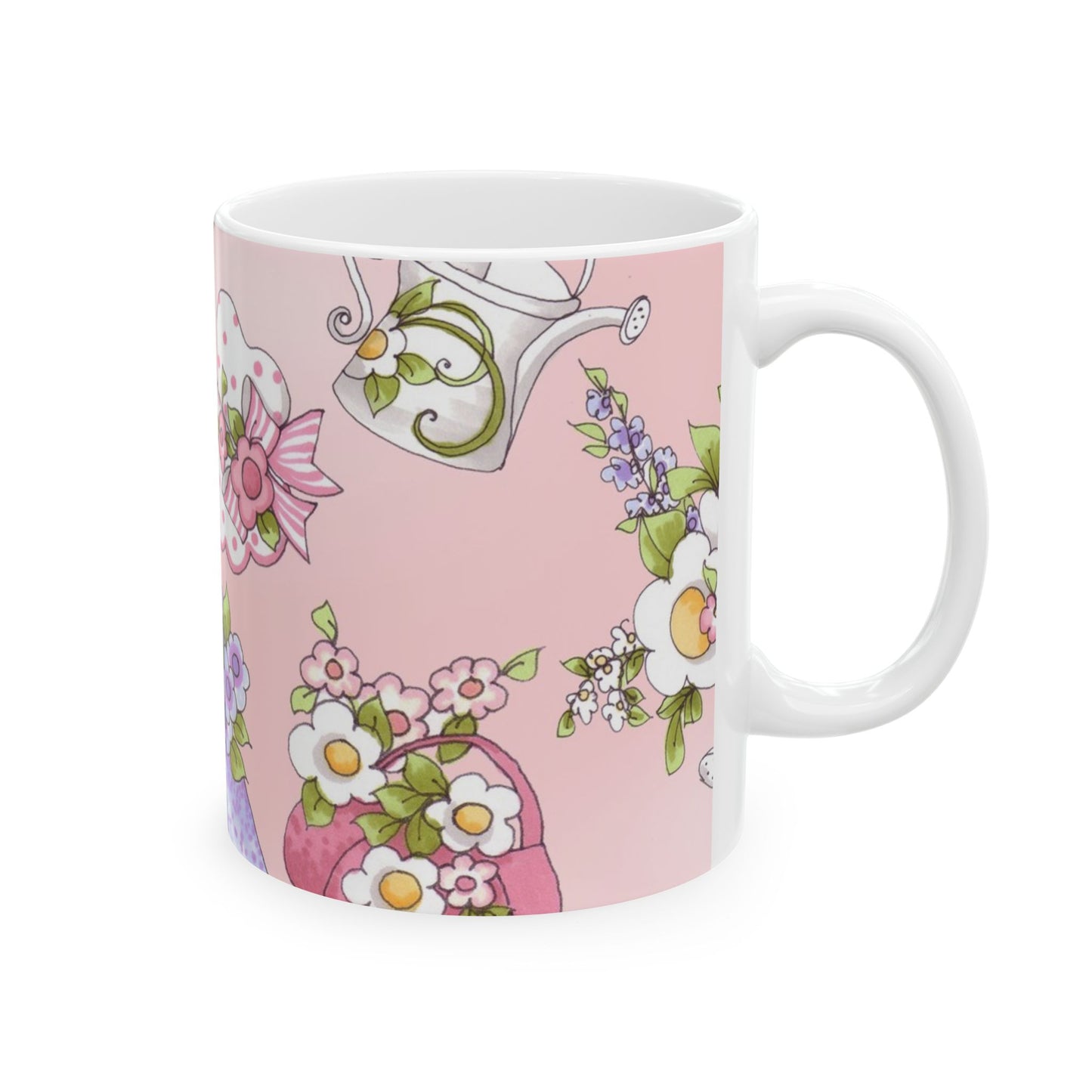 White mug with pink background, floral designs, and a watering can illustration.