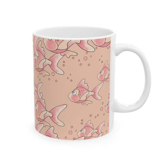 White mug with pink fish and bubbles pattern on a beige background.
