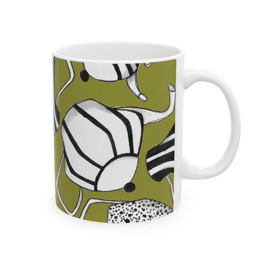 White mug with abstract black-striped shapes on an olive green background.