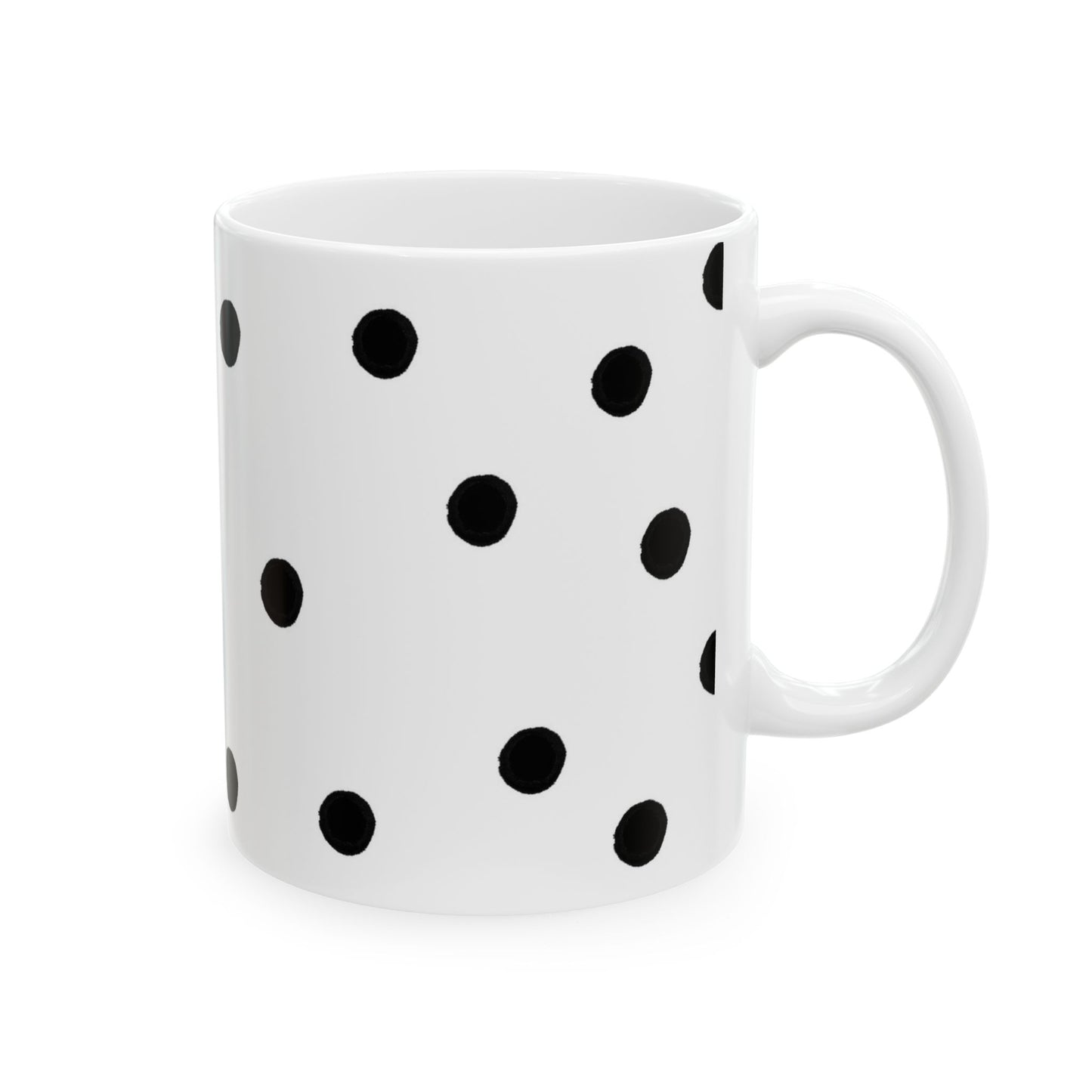 White mug with black polka dots evenly spaced, featuring a simple curved handle.