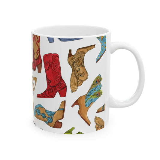 White mug with colorful cowboy boot illustrations, featuring red, brown, and blue designs.