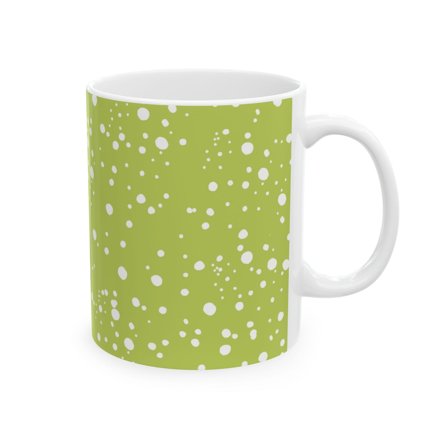 White mug with green background and scattered white polka dots pattern.