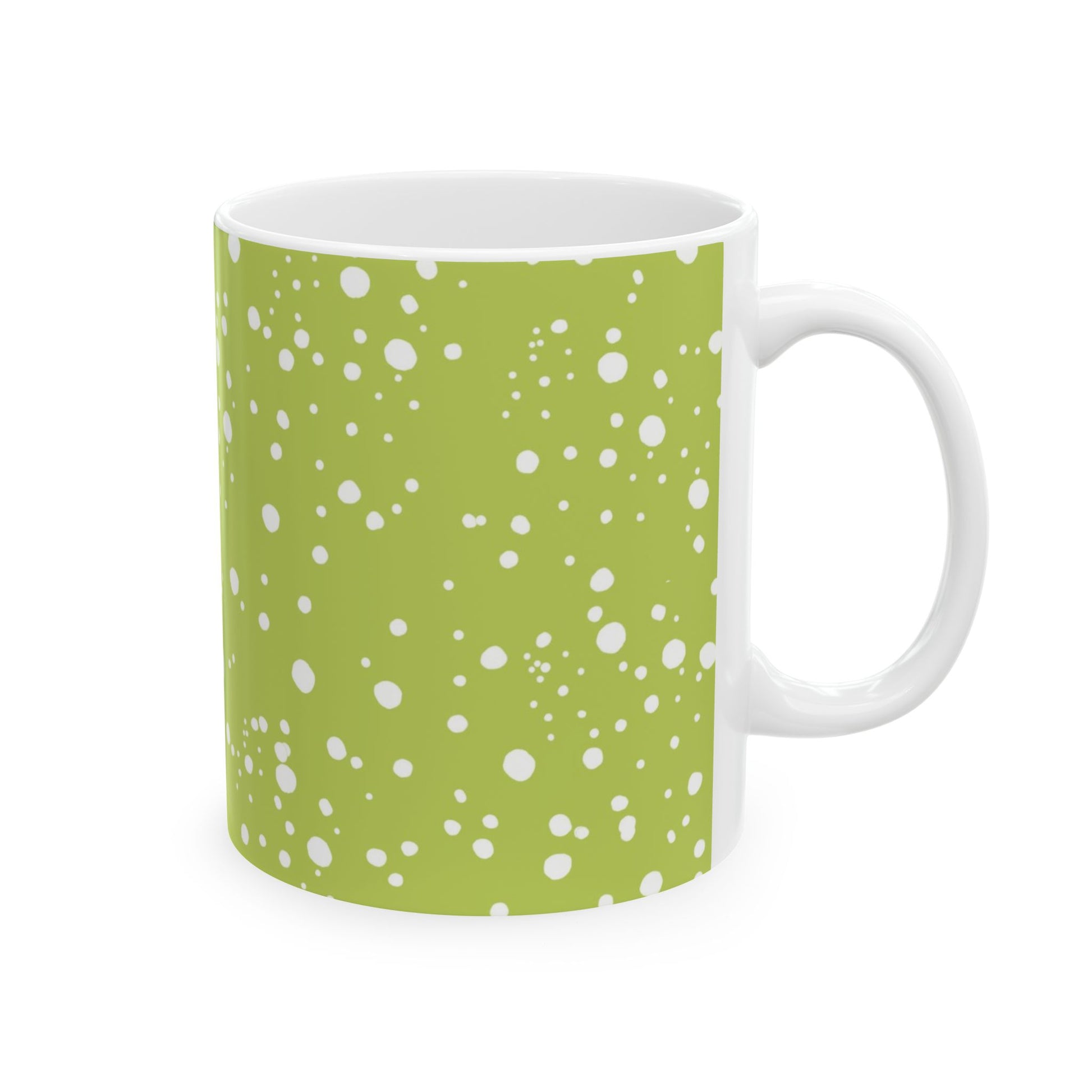 White mug with green background and scattered white polka dots pattern.