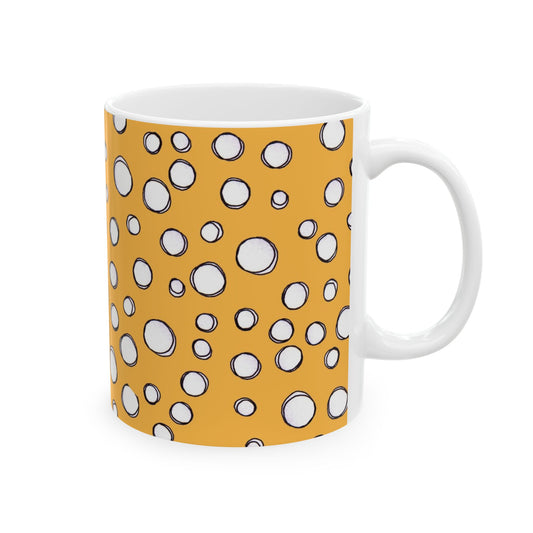 White mug with an orange background, featuring white circles outlined in black.