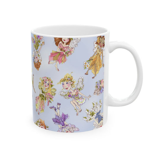 White mug with colorful fairy illustrations on a light blue background.