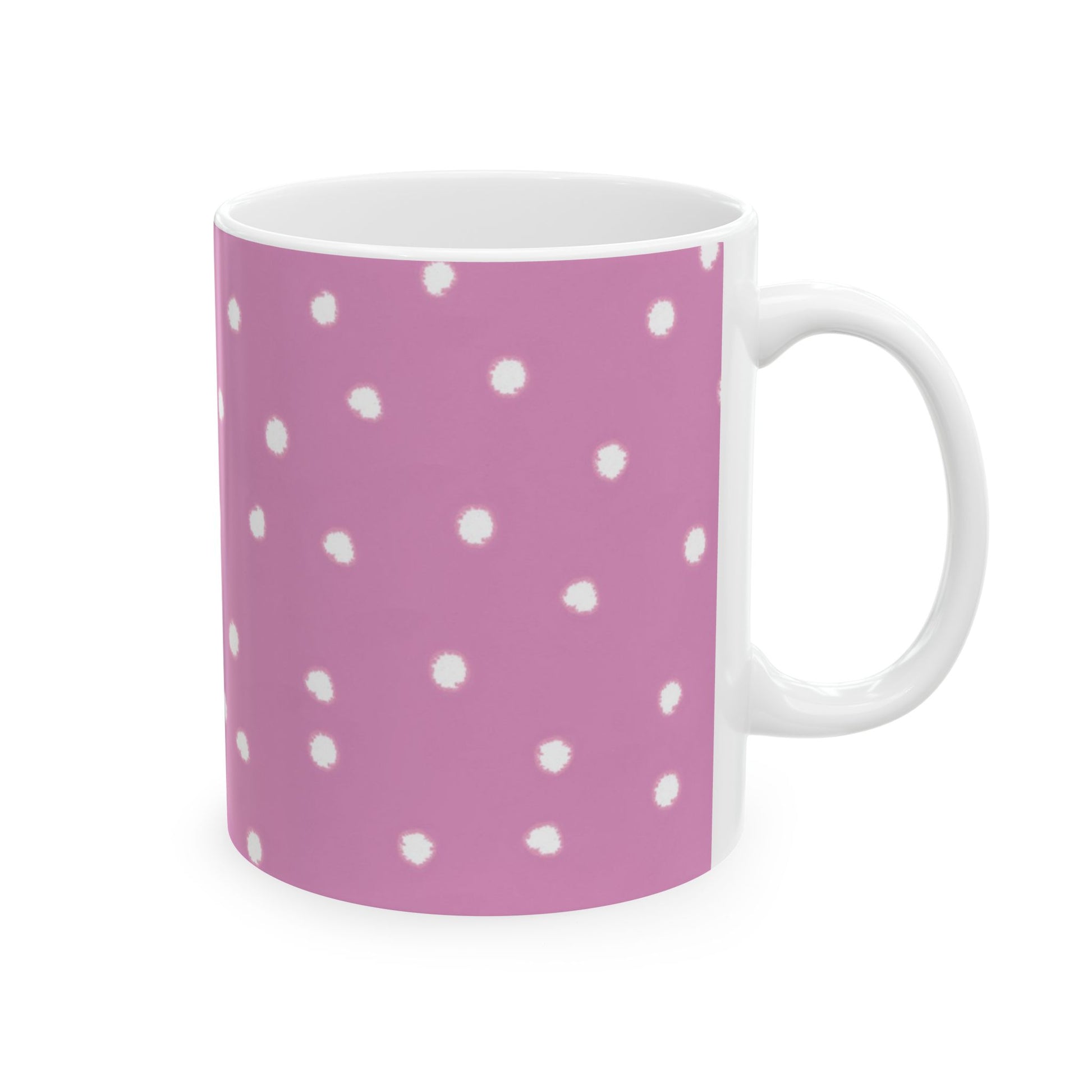 Pink mug with white polka dots, featuring a smooth handle on the right side.