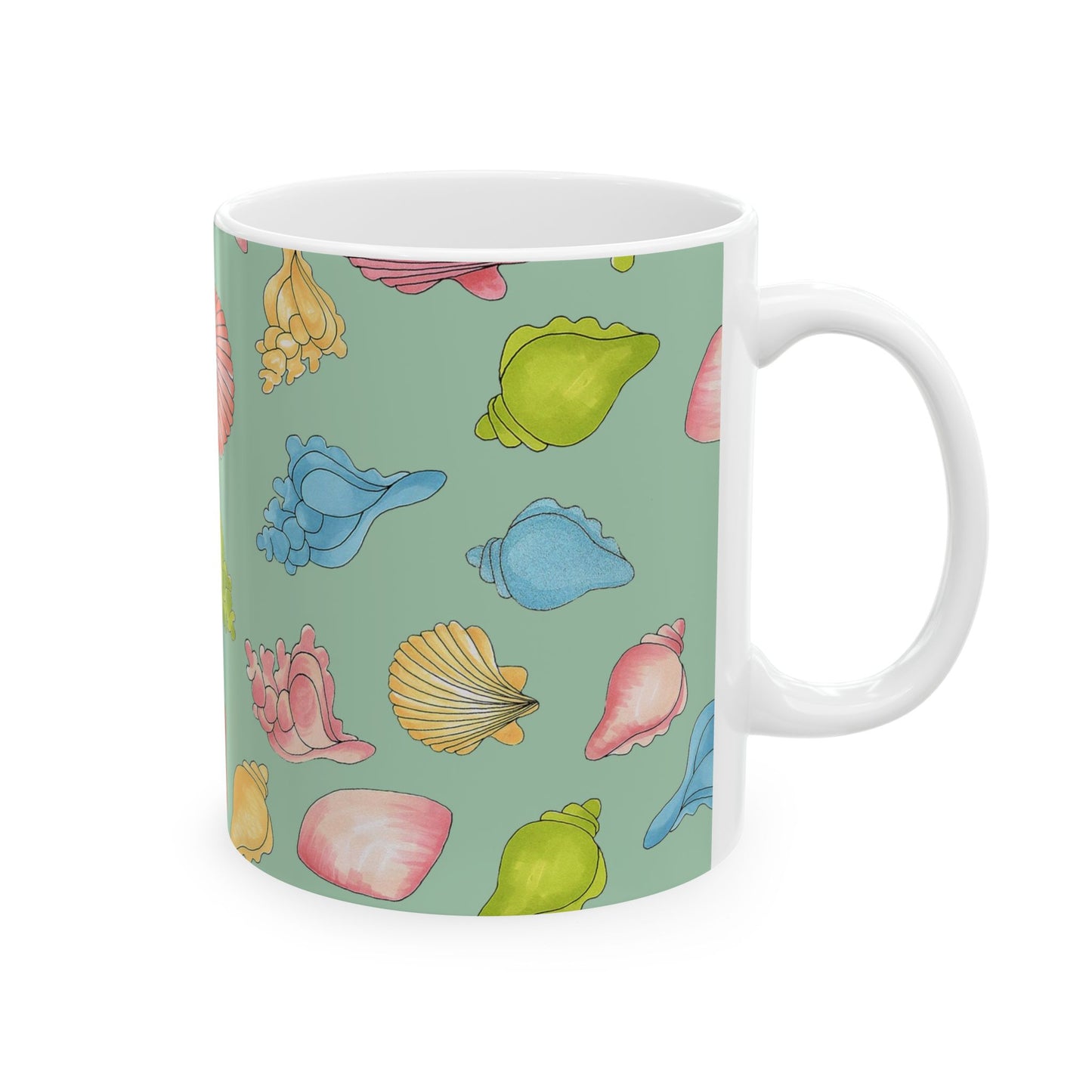 White mug with colorful seashells on a green background.