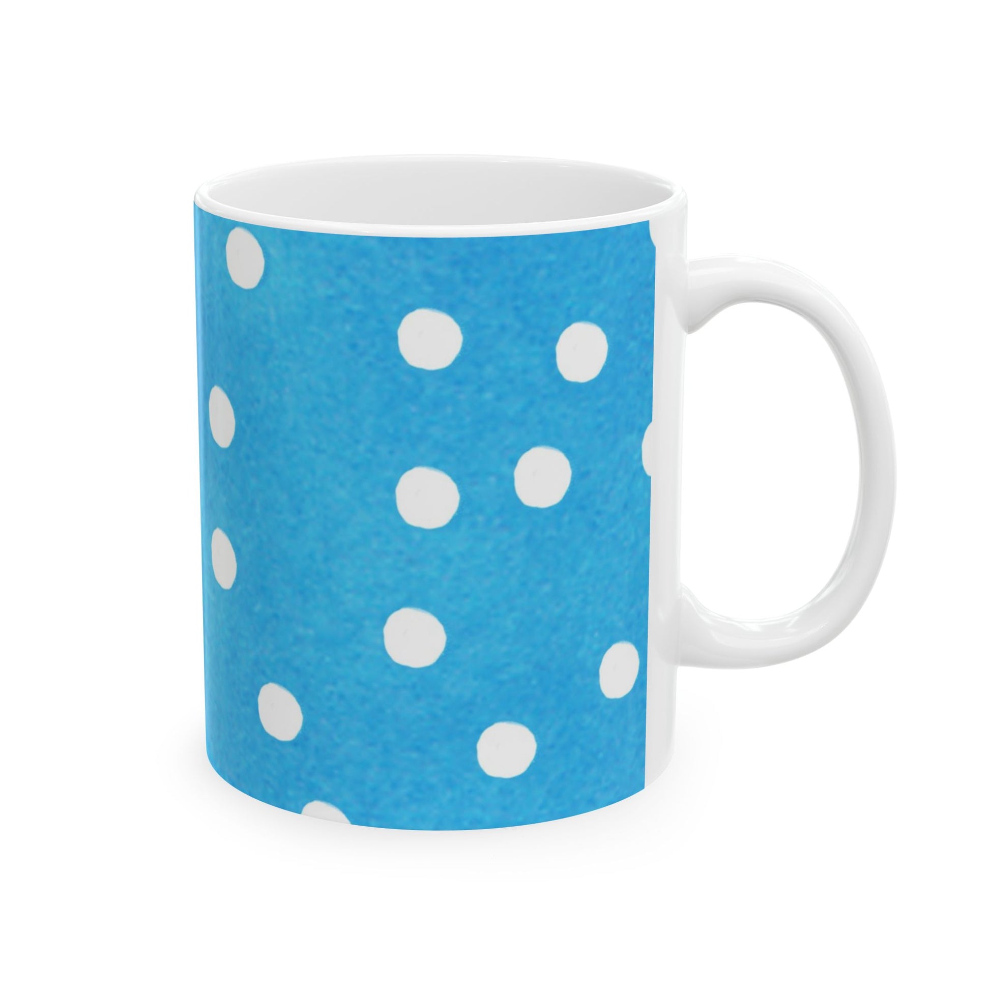 Blue mug with white polka dots and a white handle.