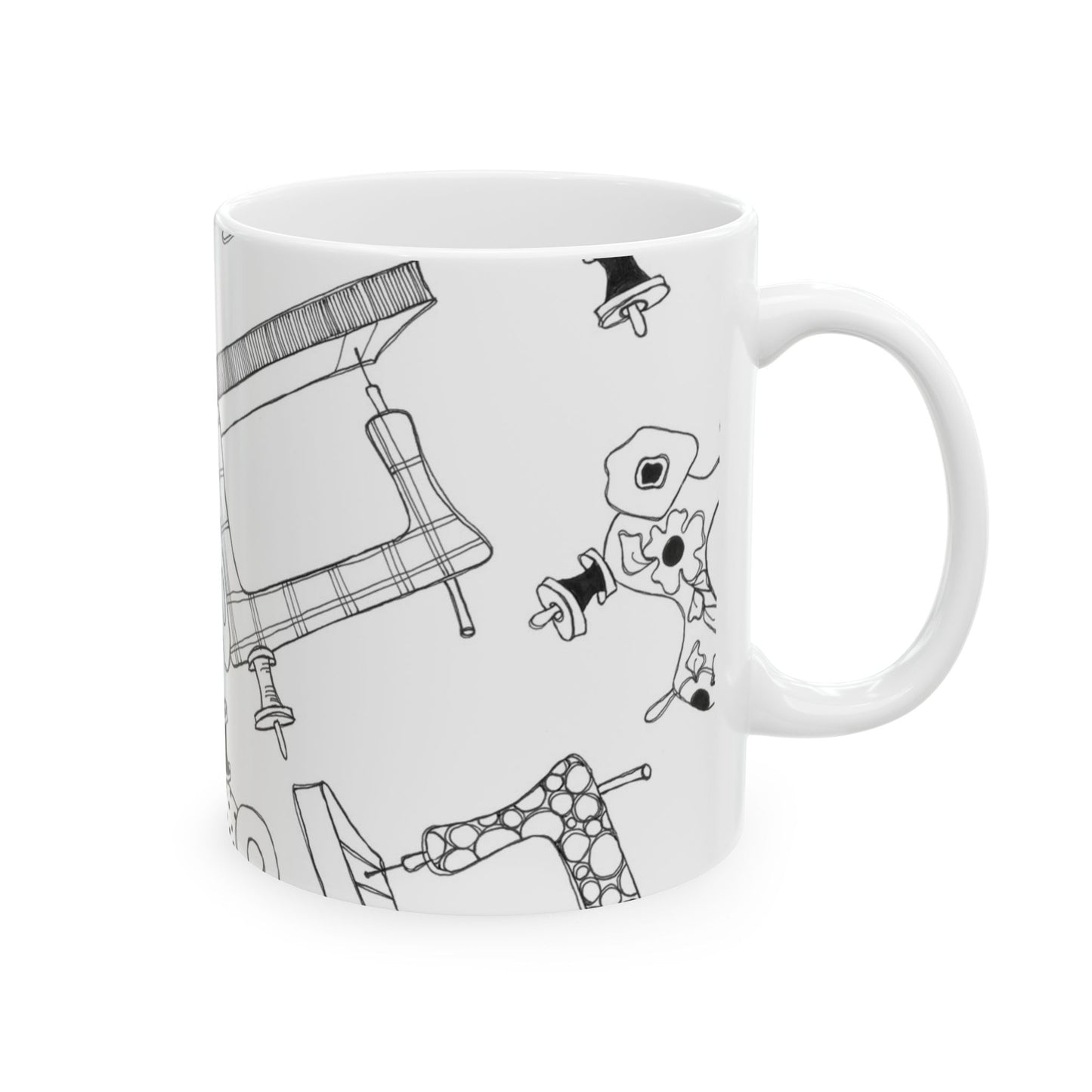 White mug with abstract black line drawings of sewing machines and floral patterns.