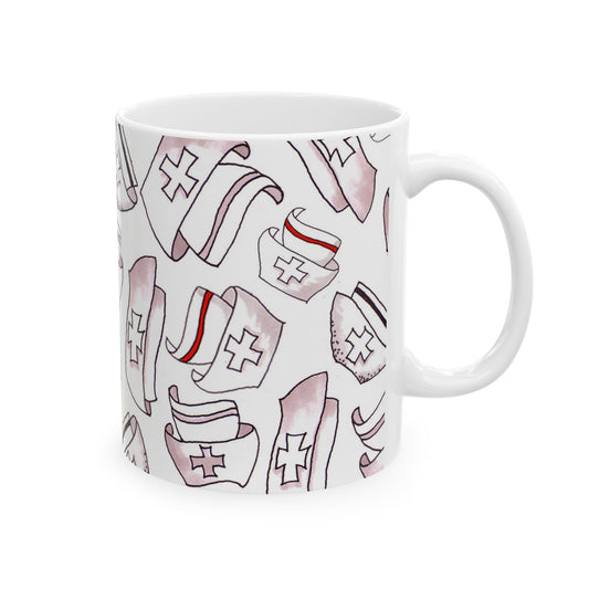 White mug with a pattern of nurse hats, red and black stripes, and cross symbols.