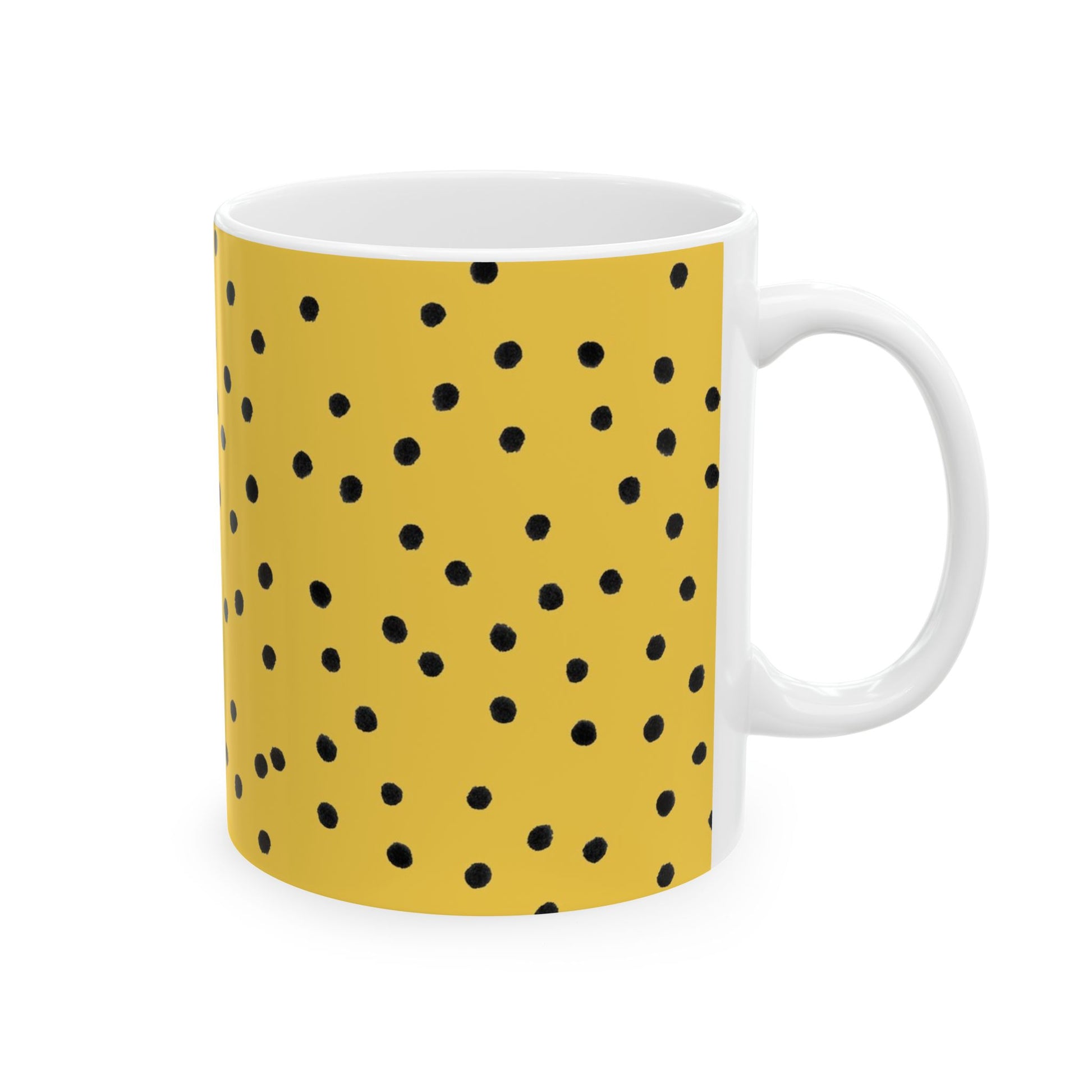 Yellow mug with black polka dots, white interior, and a simple handle on the right.