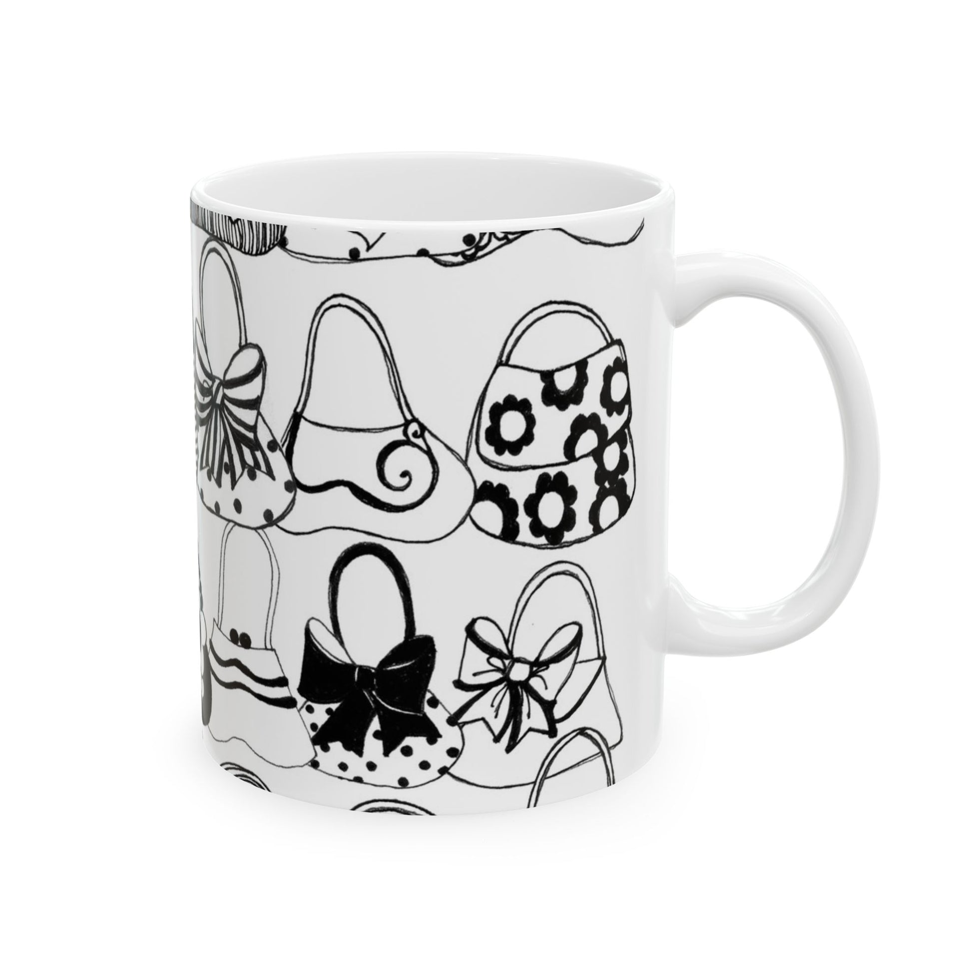 White mug with black outlined handbag illustrations, various patterns like bows and flowers.