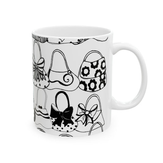 White mug with black outlined handbag illustrations, various patterns like bows and flowers.